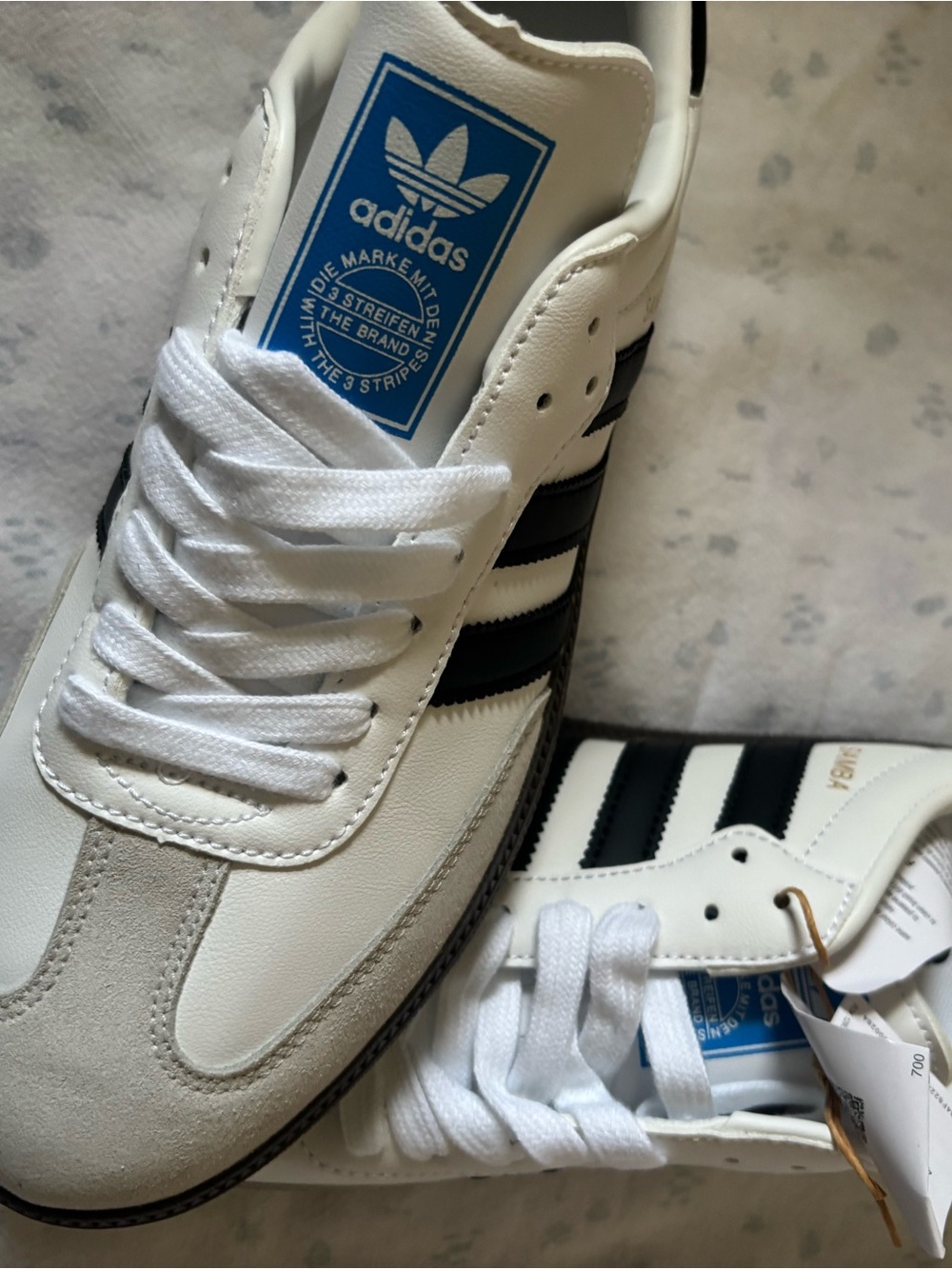 adidas White and Black Low-Top Sneakers with Blue Tongue Logo